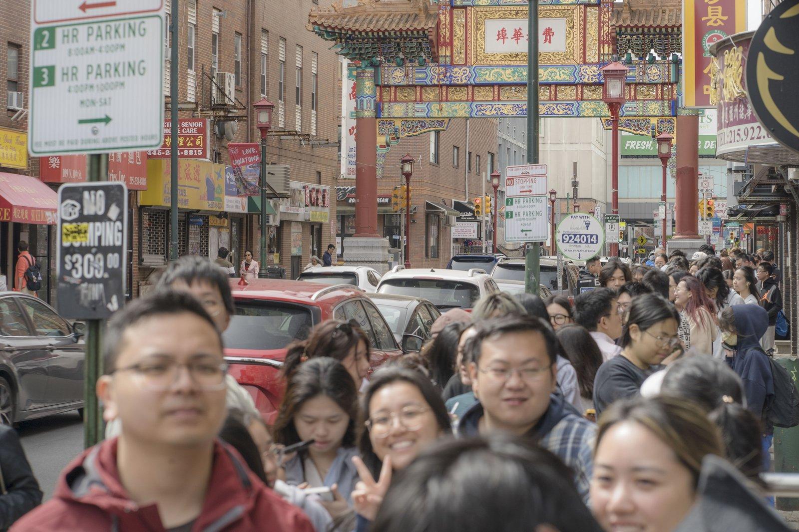 A busy street beneath the Philadelphia Chinatown gate