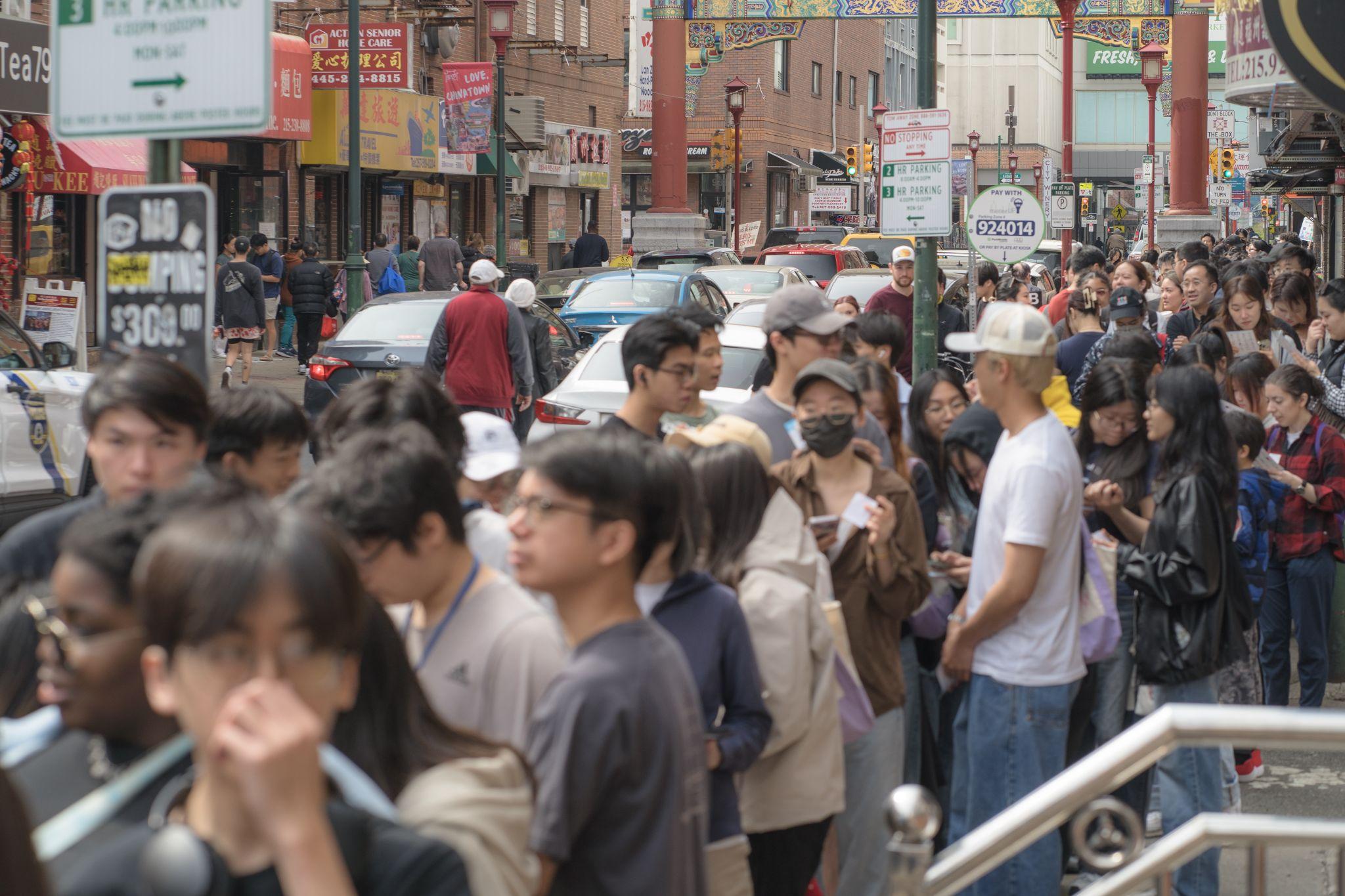 Crowds and traffic on a street in Philadelphia Chinatown