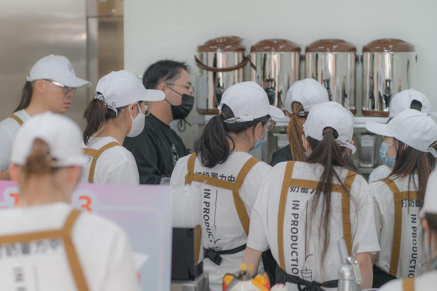 The Saskatoon Yogost team working behind yogurt machines