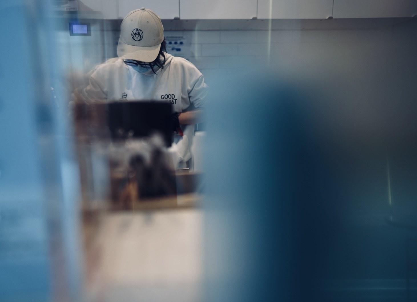A team member preparing drinks behind glass at Lansdowne
