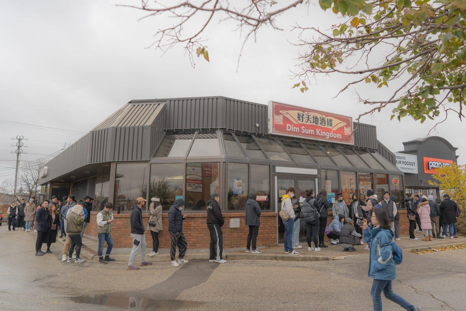 A line wrapping around the Winnipeg Yogost storefront