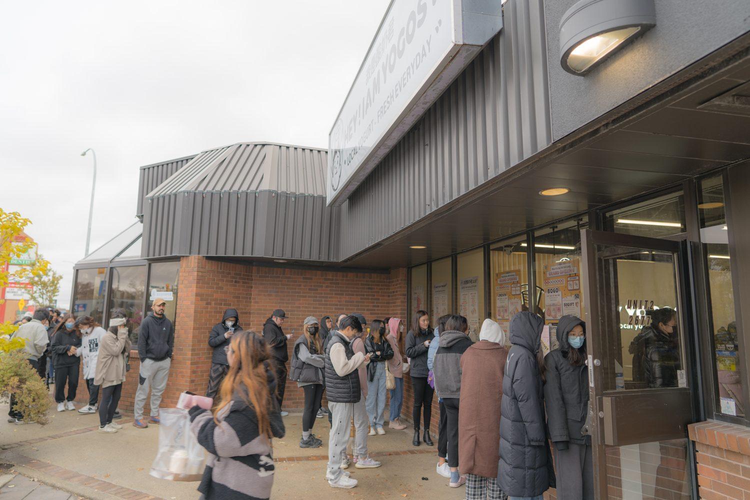 Customers waiting outside the corner Yogost store in Winnipeg